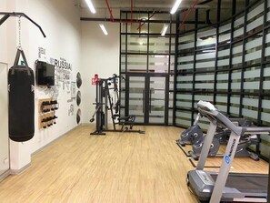 A gym with a punching bag, Nautilus elliptical, and weight machines. - w* | 1BR near Central Restaurant in Barranco (Barranco)
