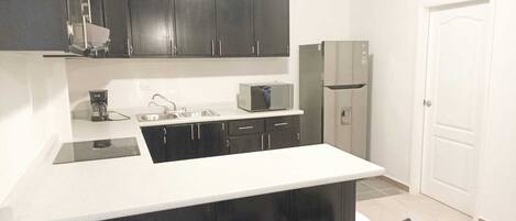 Microwave, coffee/tea maker, cookware/dishes/utensils, dining tables