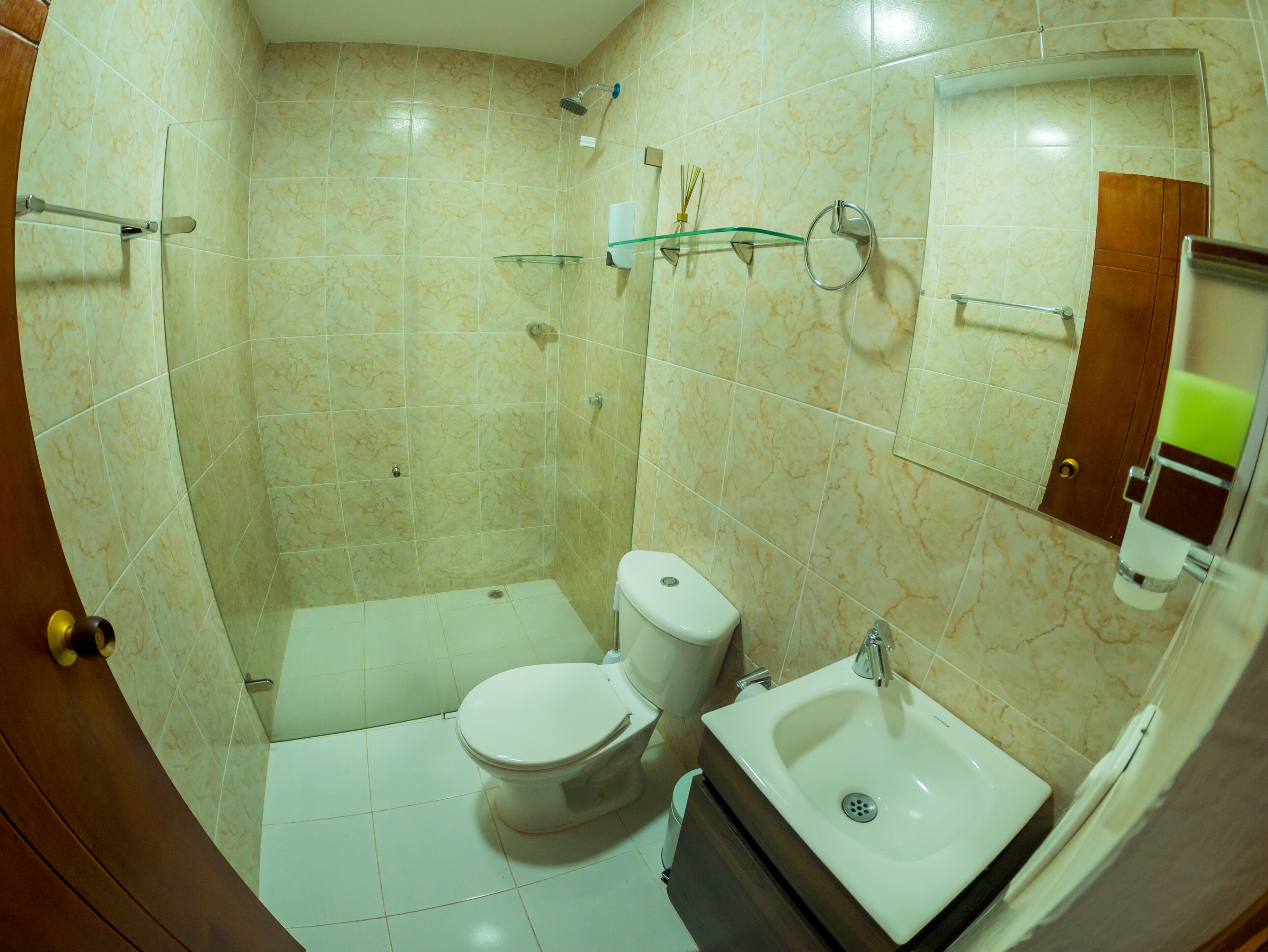 Een badkamer met toilet, wastafel en douche.