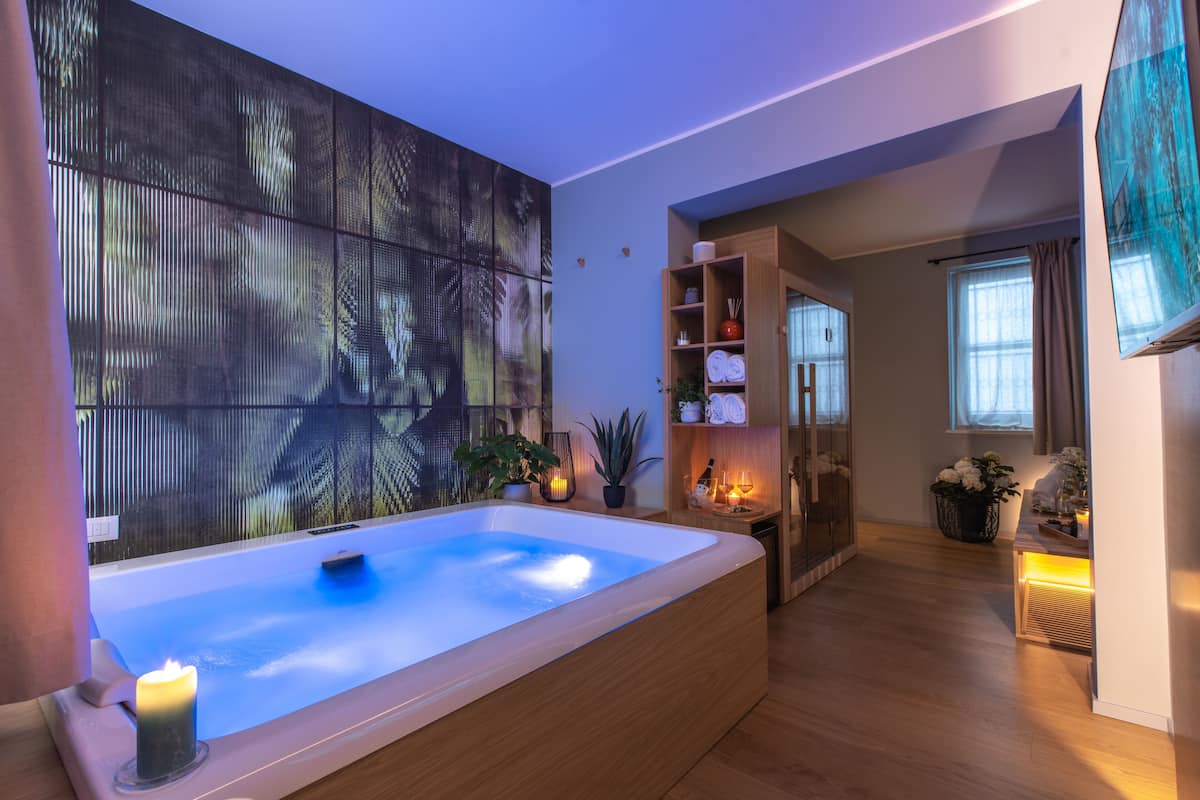 A modern bathroom with a freestanding bathtub, a large mirror, and a wooden vanity.