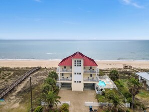 A two-story beachfront property with a swimming pool and a beach view. - Beach Buzz: Beachfront, Private Pool, Hot Tub (St. George Island)