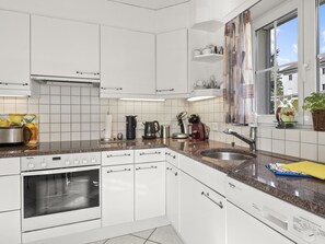 Fridge, dishwasher, high chair, cookware/dishes/utensils