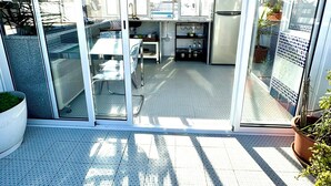 A modern kitchen with a sliding glass door leading to a patio area.