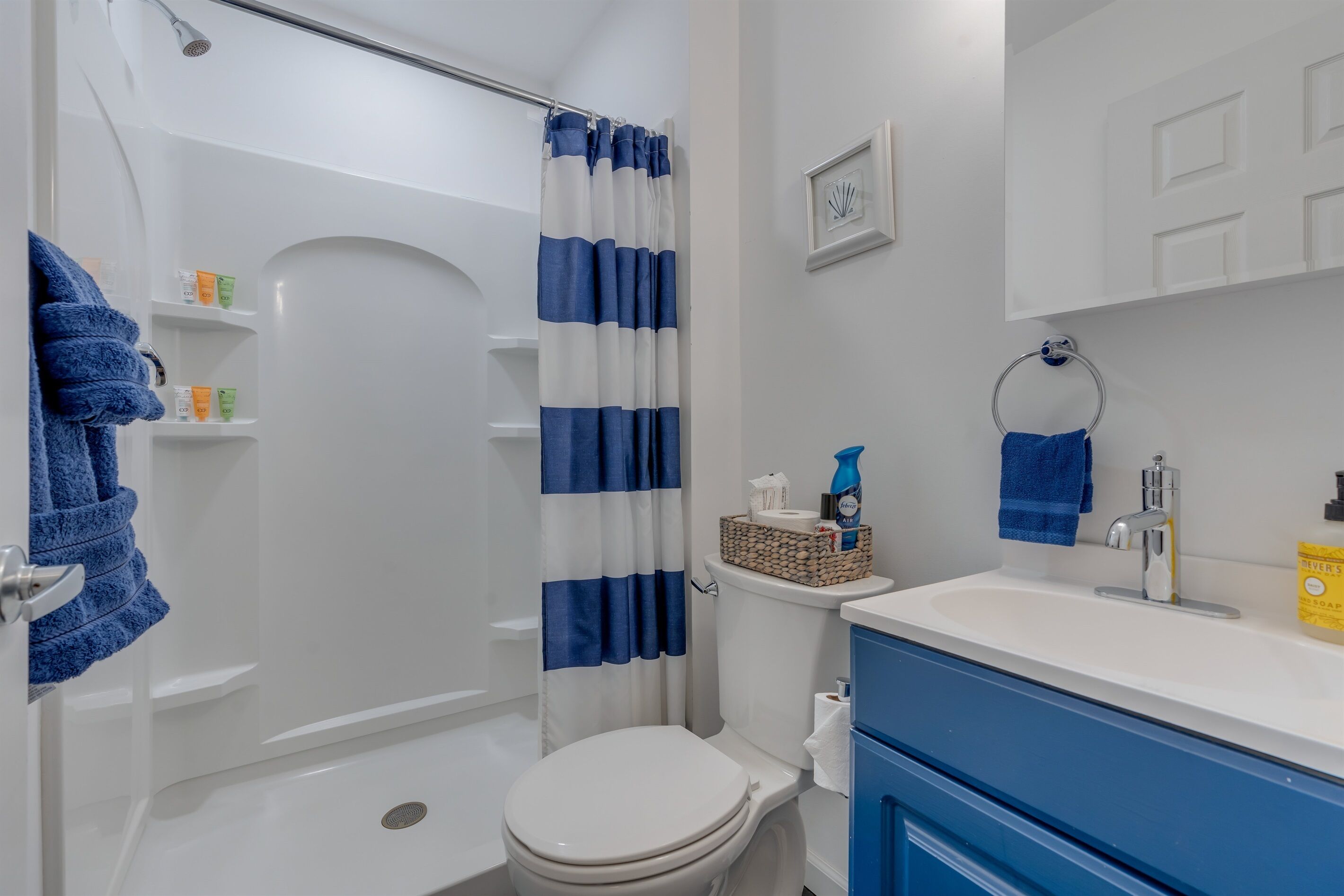 Et badeværelse med brusebad, toilet og vask.