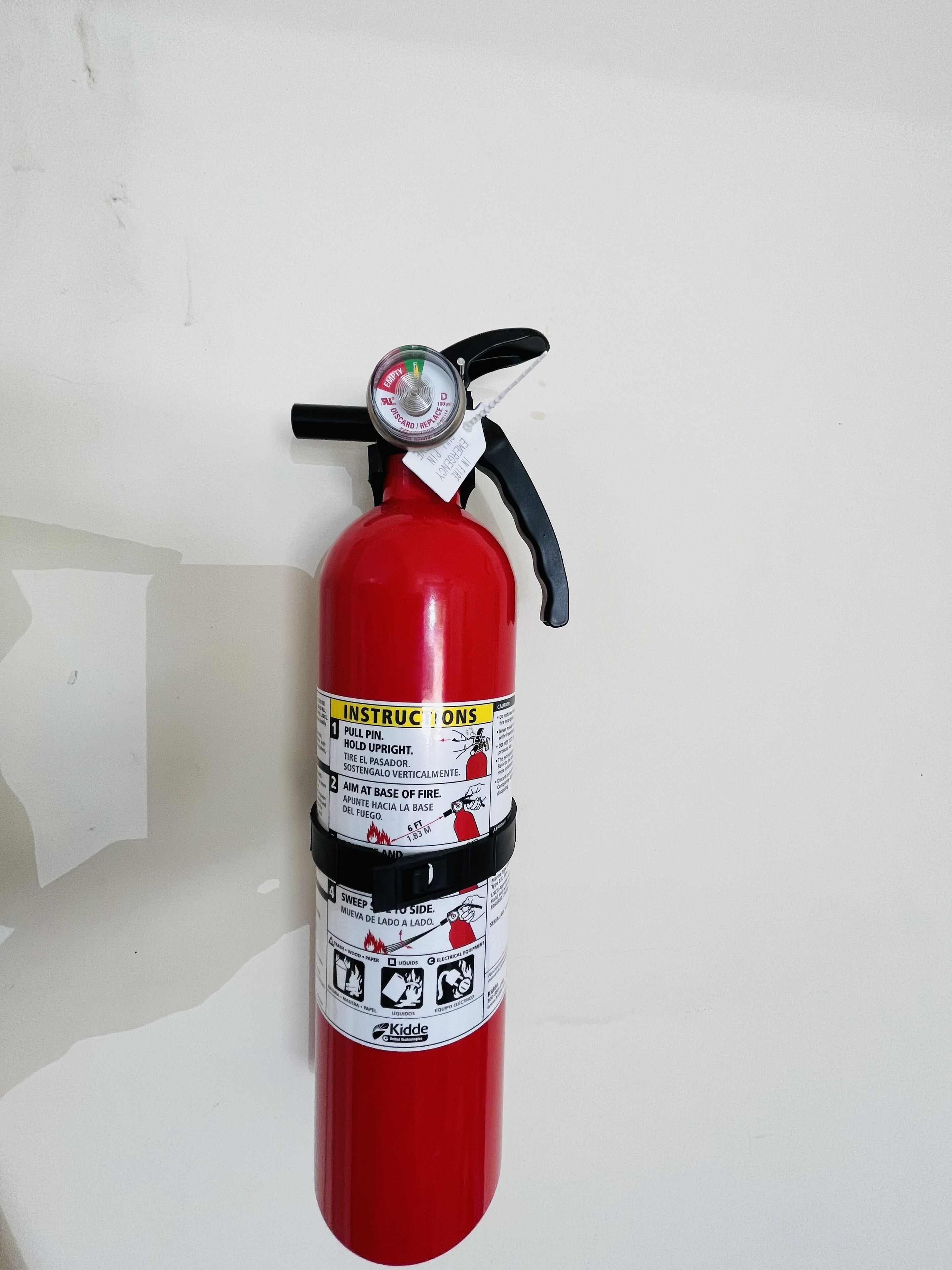 A red fire extinguisher mounted on a wall.