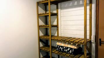 Una cama litera con estantes de madera, una pared blanca y una puerta.