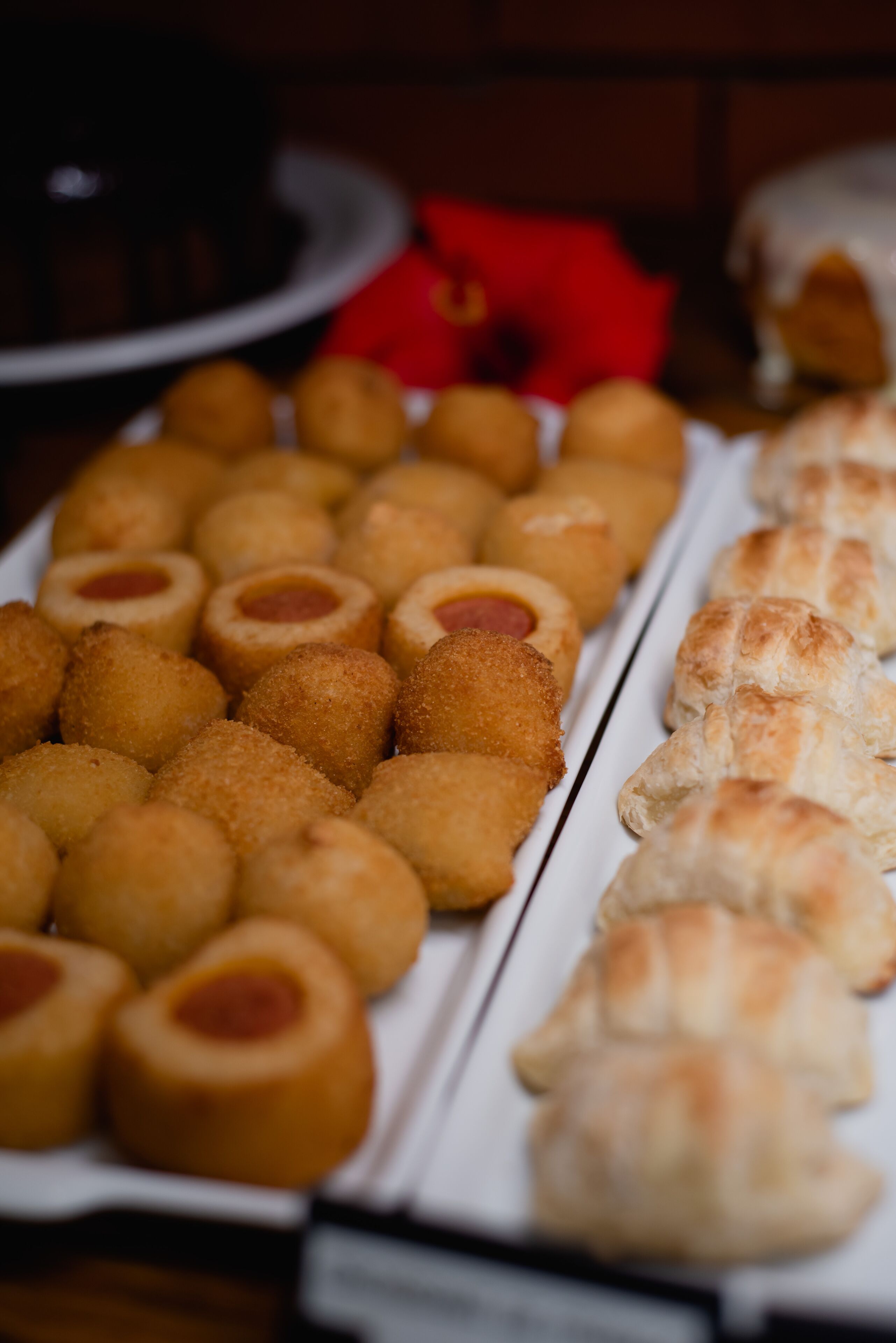 A variety of fried and baked snacks arranged on a tray.