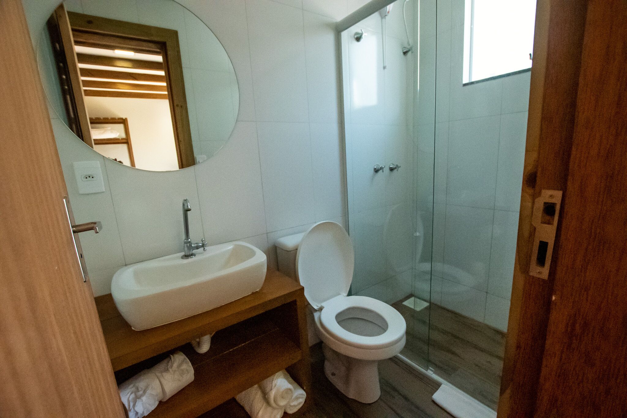 A bathroom with a sink, toilet, and shower.