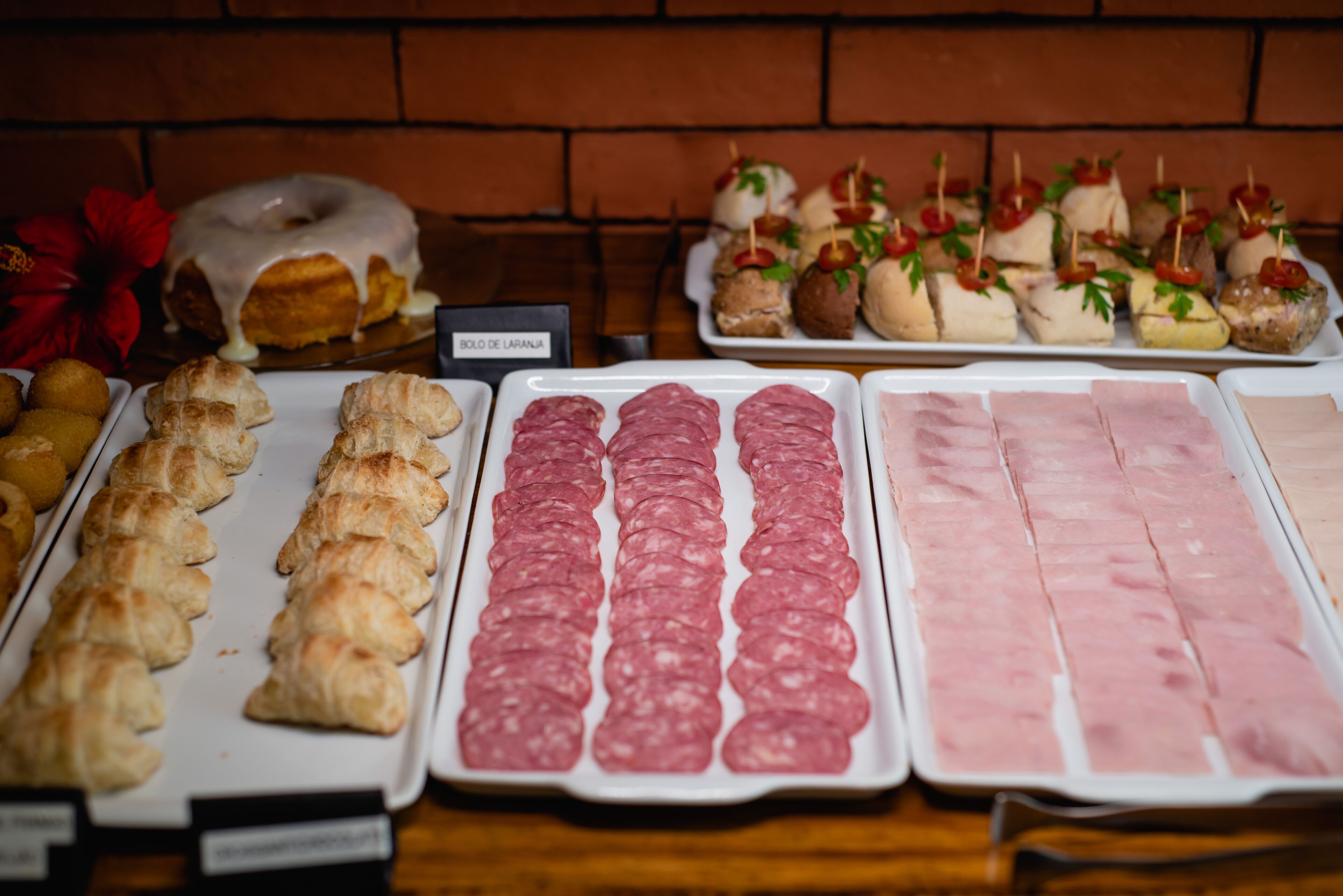 A variety of food items including pastries, meats, and a donut with icing.