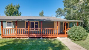 A single-story house with a porch, a small front yard, and a pathway leading to the entrance. - Dolores Ranch Cabin w/ Hot Tub & 1-Acre Yard! (Dolores)