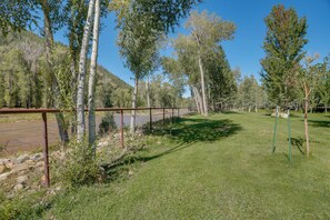 A grassy area with trees and a metal fence, likely part of a park or natural reserve. - Dolores Ranch Cabin w/ Hot Tub & 1-Acre Yard! (Dolores)