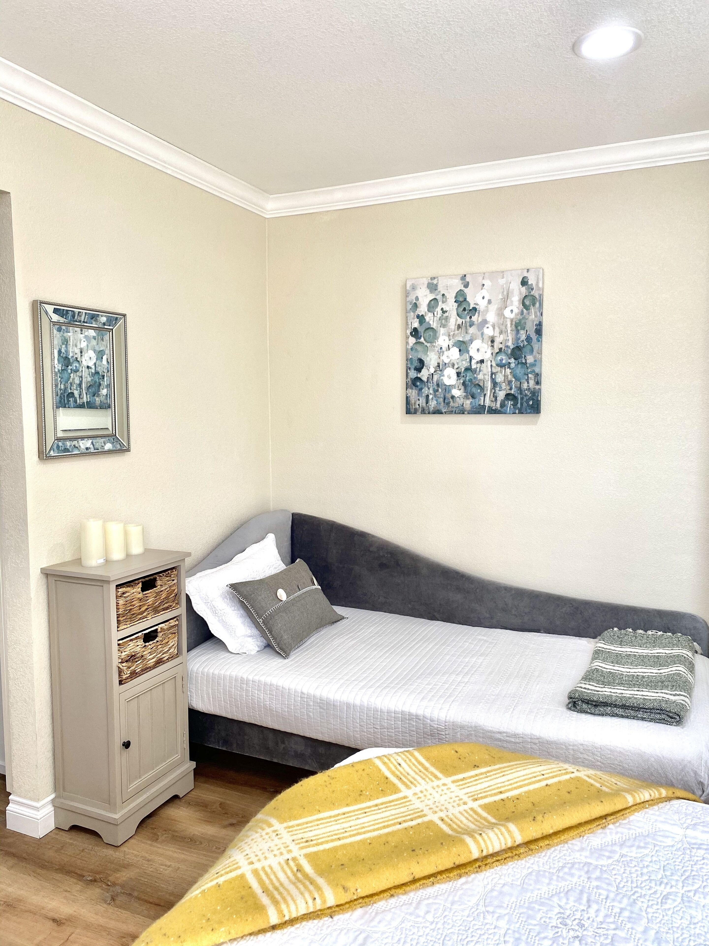 A bedroom with a bed, bedside table, and a wardrobe.