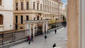 Un carrer empedrat amb edificis històrics, incloent-hi un edifici destacat amb una cúpula i columnes.