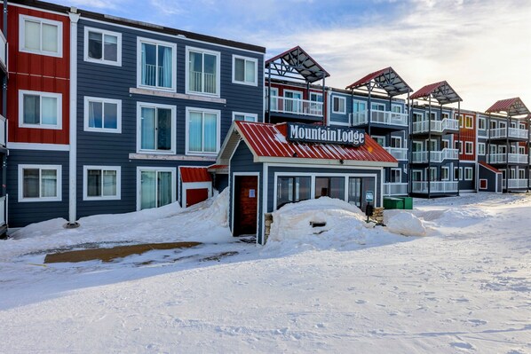 Una hilera de edificios de varios pisos con un letrero que dice "Mountain Lodge".