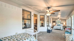 A cozy bedroom with a bed, a desk, and a chair. There is a window and a ceiling fan. - Granbury Home w/ Lake Granbury Access + Dock! (Granbury)