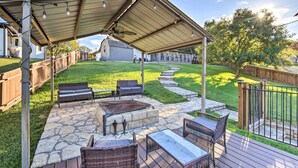 A covered patio with stone flooring, outdoor furniture, and string lights. - Granbury Home w/ Lake Granbury Access + Dock! (Granbury)