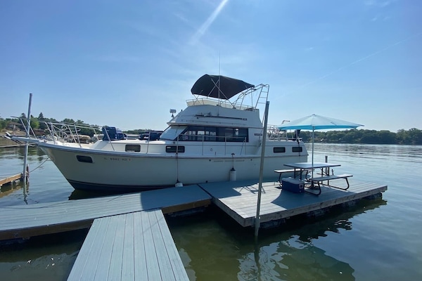 Entry to the boat is on the side or up a ladder on the back. Railings wrap around the entire yacht.