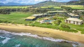 A resort with multiple buildings, a pool, and a beach. - Oceanfront Resort, 2 QUEEN beds, water views, walk-out access to pools/ocean (Lihue)