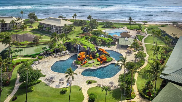 A resort with multiple swimming pools, lush landscaping, and a view of the ocean. - Oceanfront Resort, 2 QUEEN beds, water views, walk-out access to pools/ocean (Lihue)