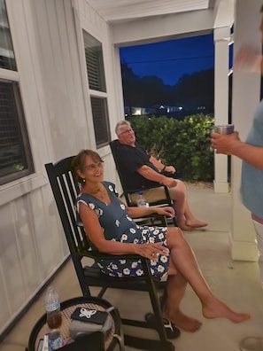 Guests can enjoy a quiet evening in this serene outdoor seating area, complete with a table and two comfortable chairs.