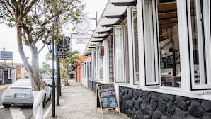 A sidewalk with a signboard for 'Bienvenidos BRUNCHA 7-9'. - Luz De Luna Hotel Barrio Escalante (San José)