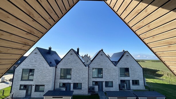 A modern building with a triangular wooden roof structure. - Vacation cottage on the dike (Büsum)
