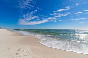 A beach with clear skies and gentle waves.