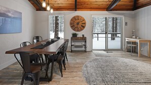 Un coin repas avec une table en bois, des chaises et une grande horloge murale.