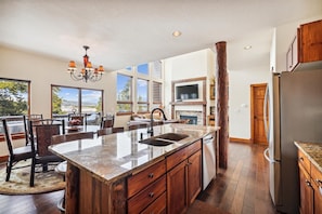 Enjoy cooking in this well-equipped kitchen with a large island, sink, and ample counter space.