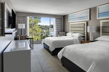 Relax in a stylish room with two beds, a flat-screen TV, and a seating area. at Bluegreens Bayside Resort and Spa