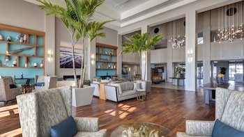 Relax in this stylish space with armchairs, sofas, and a fireplace, surrounded by lush greenery and natural light. at Bluegreens Bayside Resort and Spa