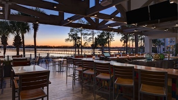 Enjoy al fresco dining with a view of the water from this outdoor space, featuring comfortable seating and a modern design. at Bluegreens Bayside Resort and Spa