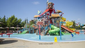 A water park with a large slide, a wave pool, and a sign reading "Solaris Aquapark".