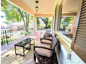 Relax on the covered porch with a glass-top table and four comfortable chairs.