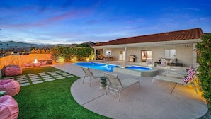 A backyard with a swimming pool, outdoor seating, and a patio area. - PinkBlissHouz: Pool, Spa, Firepit, Themed Rooms (Desert Hot Springs)