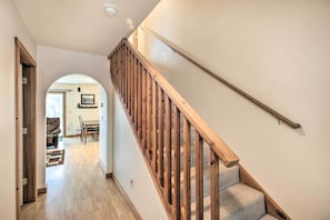 A staircase with wooden railings leading to a landing.