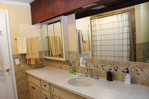 Combined shower/bathtub, towels, toilet paper