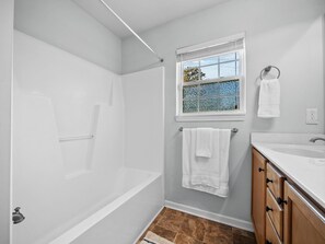 Bathtub, towels, soap, toilet paper