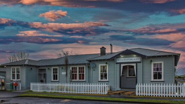 A two-story building with a sign reading "The Old Post Office Lodge".