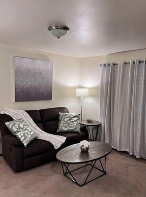 Relax in this stylish living room with a sofa, coffee table, and floor lamp.