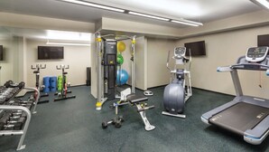 A gym with various exercise equipment including dumbbells, a treadmill, and a stationary bike. - 1BD/Austin - Rooftop Pool & Firepit, BBQ! (Austin)