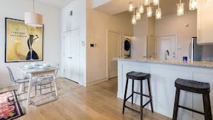 A modern kitchen with a central island, bar stools, and pendant lighting. - ✪ Best Apartment in Westport Kansas City ✪ (Kansas City)