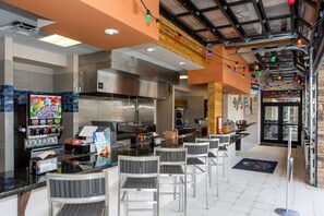 Enjoy a meal in our restaurant with a bar area, ice cream vending machine, and open kitchen.