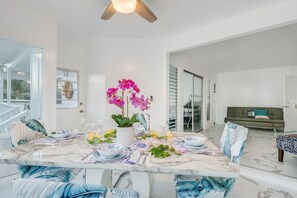 Enjoy meals in this stylish dining area with a marble table and comfortable seating.