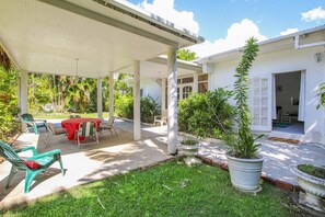 The airy covered front verandah with casual seating - a great lounging space