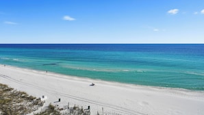 A beach with clear turquoise water and a sandy shore.