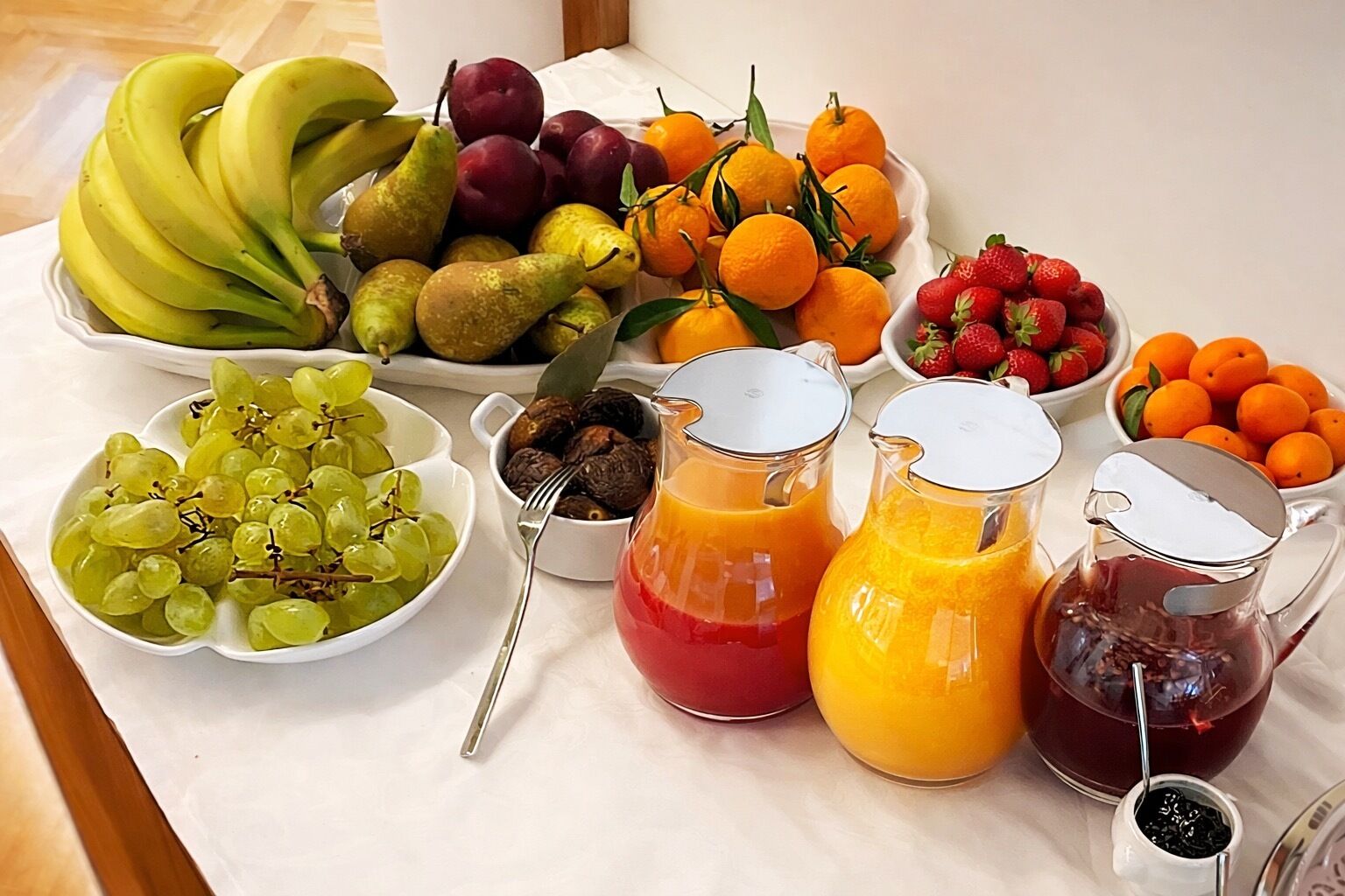 A table with various fruits and beverages.