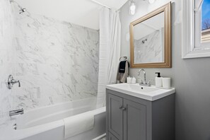 Bathtub, hair dryer, towels, soap