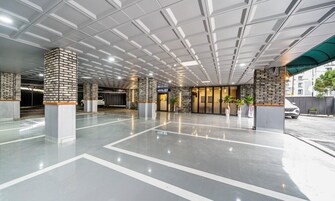 A modern hotel lobby with a polished floor, a stone pillar, and a sign for 'HOTEL G7'.