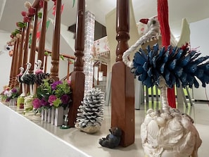 Stunning staircase features decorative sculptures and arrangements.